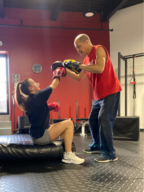 A young woman trains with one of our gym in mount kisco's personal trainers.